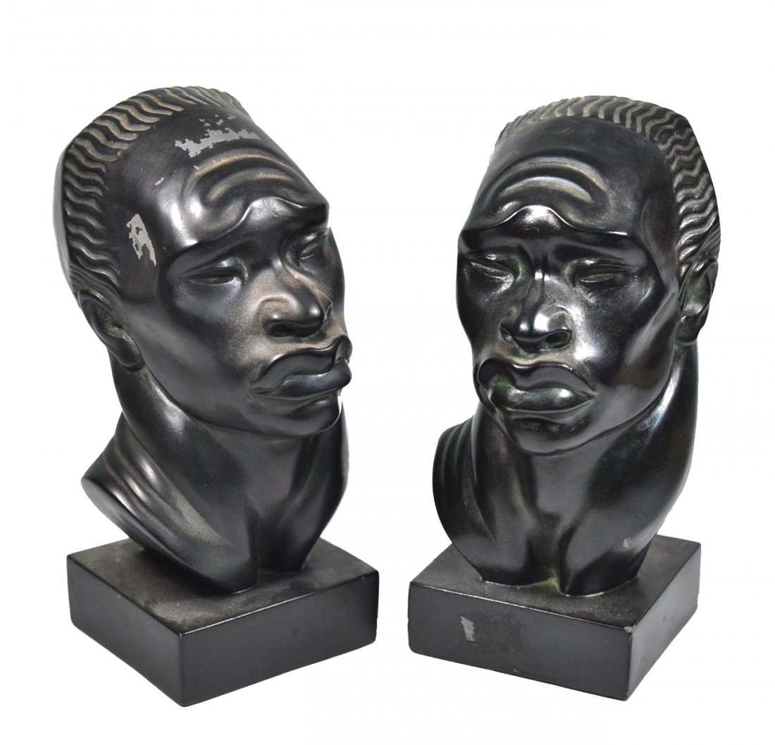 2 Vintage Fred Press African Male Busts: Identical stylized mid-century modern composition busts depicting African men with tribal headdress. [Each 4 1/2" W x 6 1/4" D x 9 1/4" H]. Chips and paint flakes with losses.