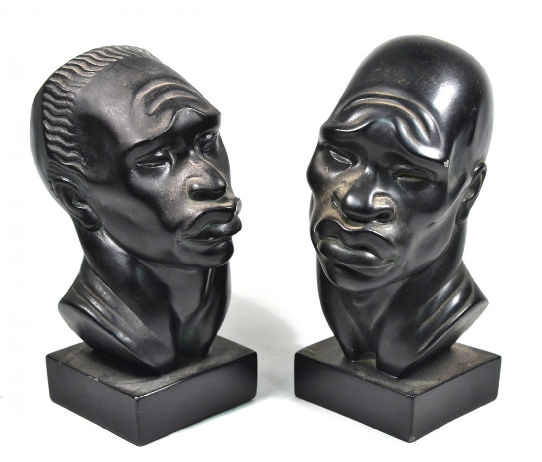 2 Vintage Fred Press African Male Busts: Vintage mid-century modern composition busts depicting African men, one with clean shaved head, the other with tribal headdress. [Larger 4 1/2" W x 6 1/4" D x 9 5/8" H]. Some chips and paint flaking w