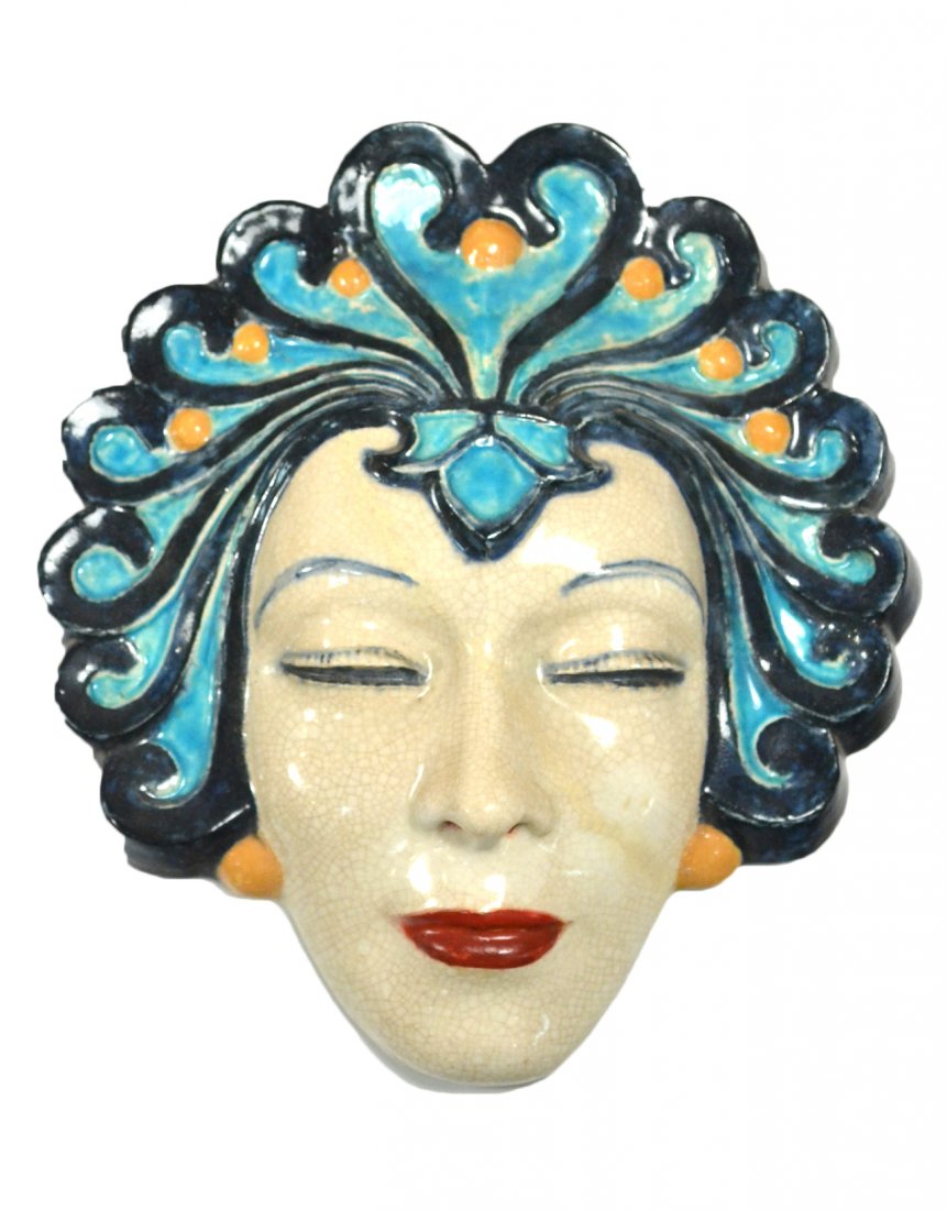 1920's Glazed Ceramic Mask of a Woman: Features the face of an exotic woman wearing a blue headdress. [10" H]. Restored.