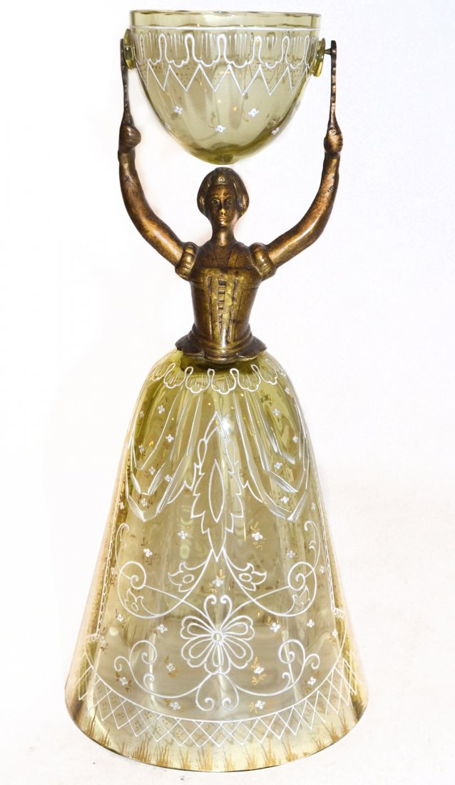 19th Century German Wedding Cup: In the form of a woman with upheld arms, supporting a hinged cup on her head. The skirt and cup both of blown and enameled glass. [8 1/4" H]. In good condition.