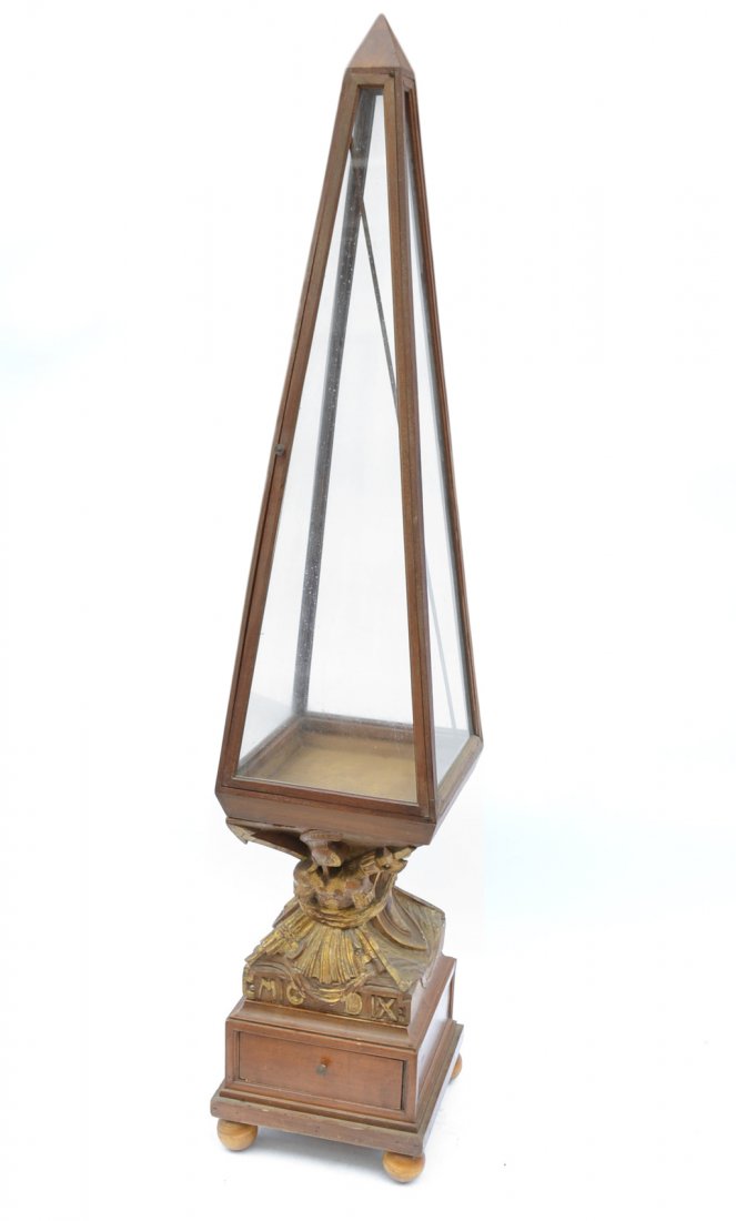 French Obelisk Vitrine Cabinet: With carved and gilt base supporting glazed obelisk. [57"H x 13 1/2" W x 14"D]. Overall surface wear.
