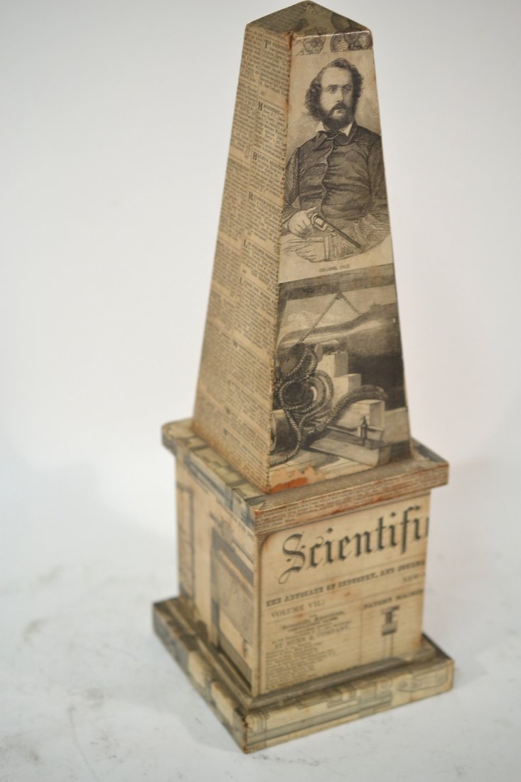 Lacopovia-Style Obelisk: Hinged paper decorated obelisk box, in the manner of Fornasetti. Missing one hinge.
