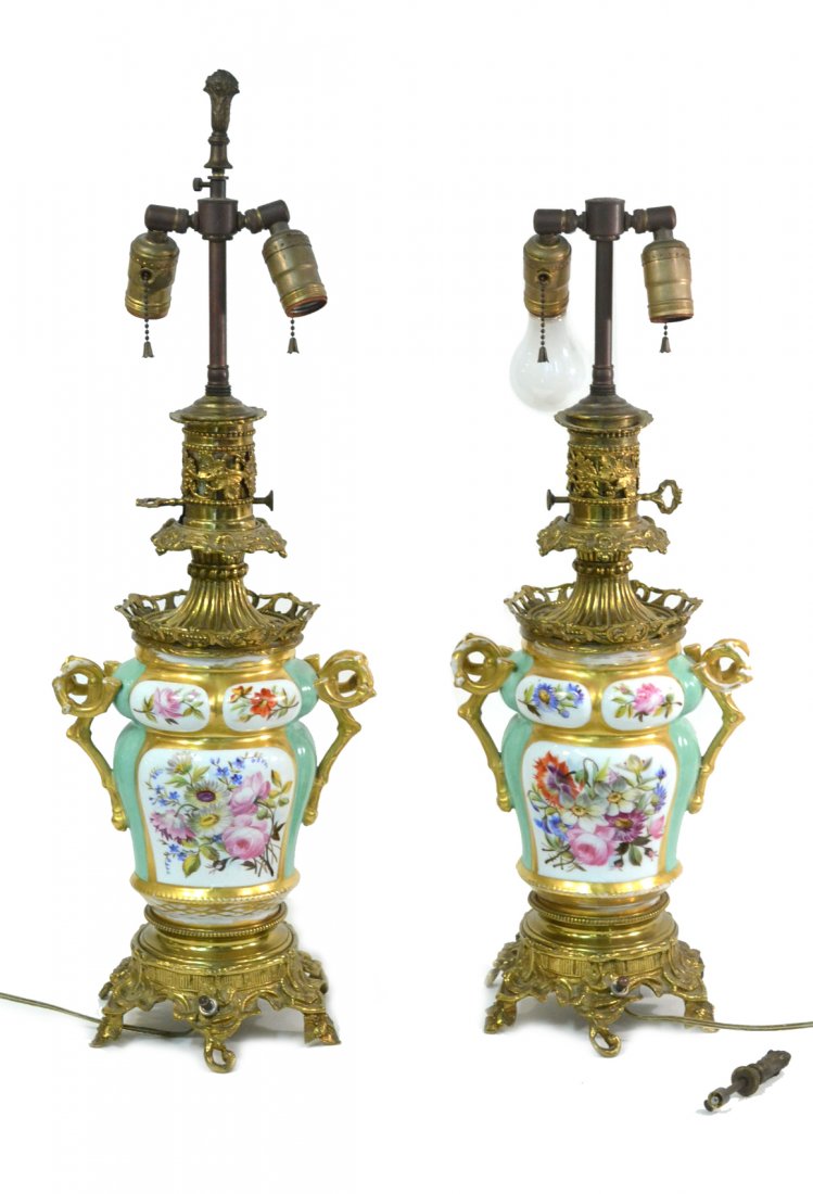 Pair of Paris Porcelain Style Lamps: Brass mounted floral decorated porcelain vases with branch-form handles. [27" H]. Significant wear to gilding.