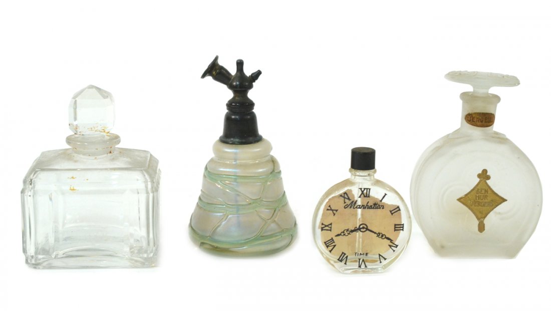 Four Perfume Bottles: Comprises: "Ben Hur", "Manhattan", A Baccarat bottle (stopper chipped),and an art nouveau atomizer in the manner of Loetz.
