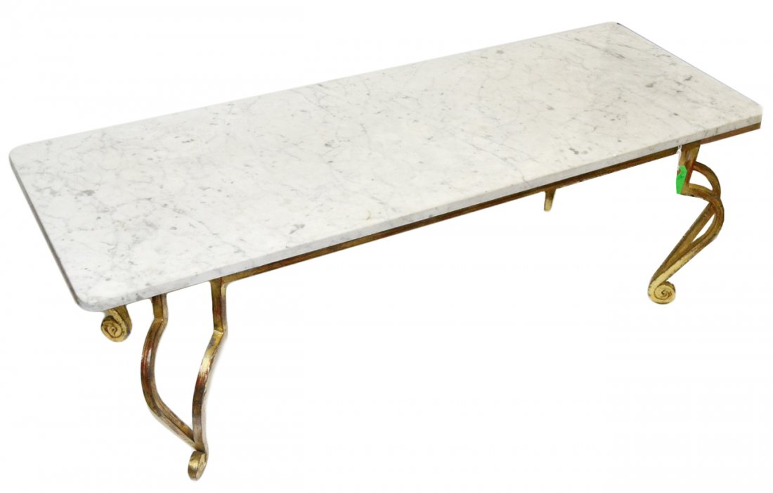 Gilt Iron Cocktail Table: French cocktail table with open-work legs, having a white marble top. [52 1/2"L x 22 1/2D x 18"H]. Good condition.