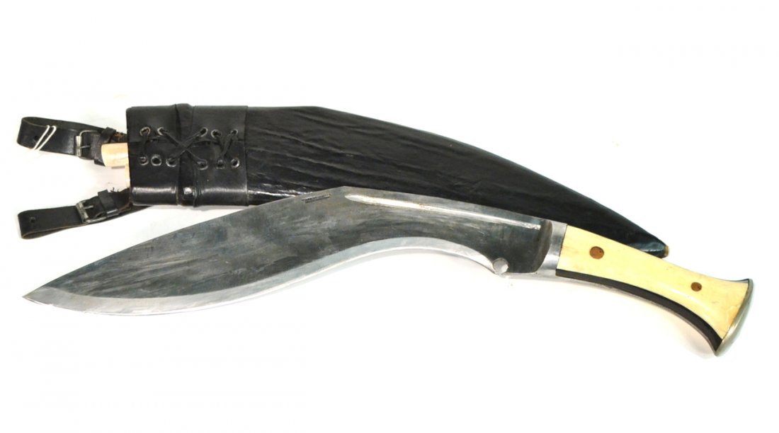 Indian Machete in Sheath: With bone handle and black leather sheath. Accompanied by two smaller knives. [18" Long]. Good condition.