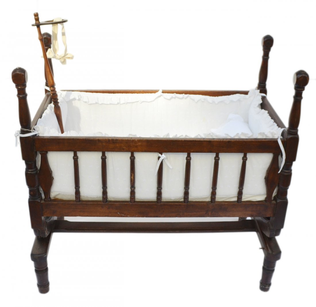 Antique American Wood Cradle: Features turned supports, mortis and through tenon construction, and wrought iron rocking mechanism. [23 1/4" W x 39 1/4" D x 38 1/4" H]. Wear consistent with age and use.