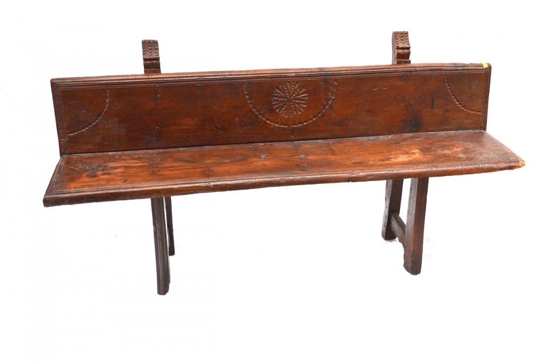 Continental Pew: Antique walnut pew with incised decoration. [67 1/2" W x 14 1/2" D x 35 1/2" H]