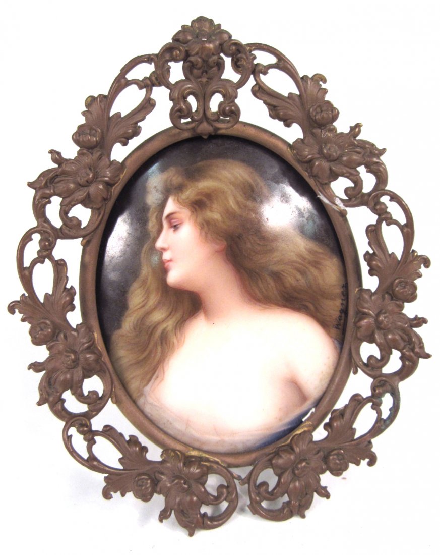 Antique German Miniature Portrait: Oval porcelain miniature depicting a woman with long auburn hair in a bust-length half profile pose. Signed center right "Wagner". [Image: 2 1/2" x 3 1/4"]. Contained in an open work bronze frame scro
