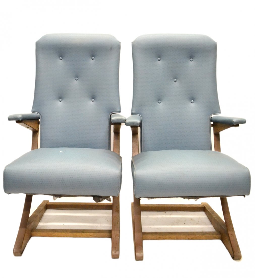 Pair of Modernist Rocking Chairs: The vinyl upholstered chair on suspension armature and with wood bases [23 1/2" W x 22" D x 44" H; Seat: 18" H]. Rust to metal, significant wear to upholstery.