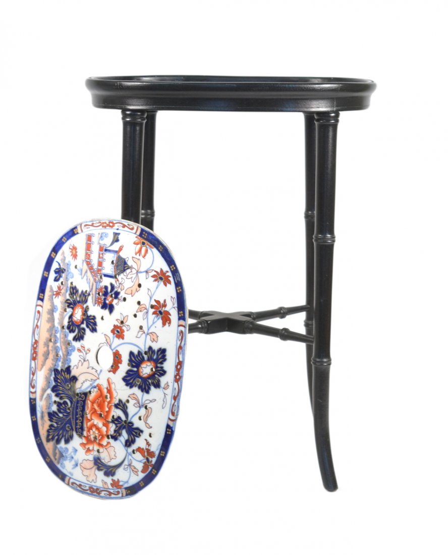 English Regency-Style Imari Stand: Faux bamboo ebonized wood frame supporting an oval English Imari pattern inset plaque. [12 3/4" W x 9 1/2" x 17 1/2"]. Good condition.
