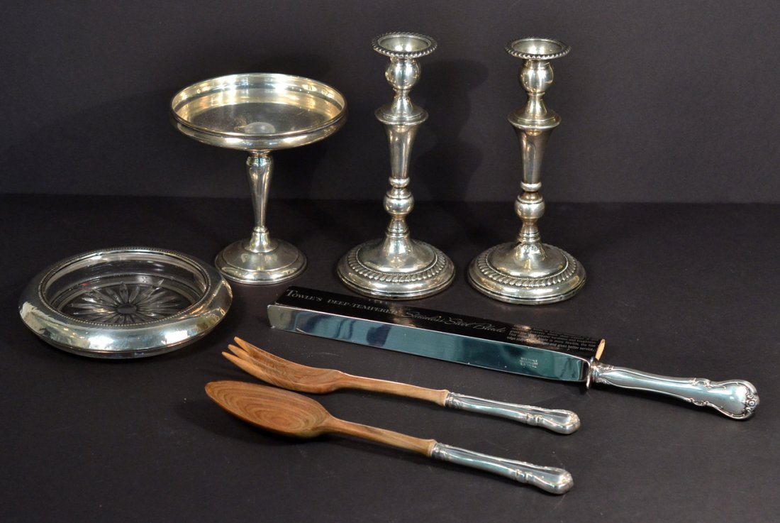 Group of 7 Sterling Articles: Comprises a pair of candlesticks, compote, bottle coaster, pair of salad servers and a carving knife. All unweighable. Dents to candlesticks, compote, and coaster.