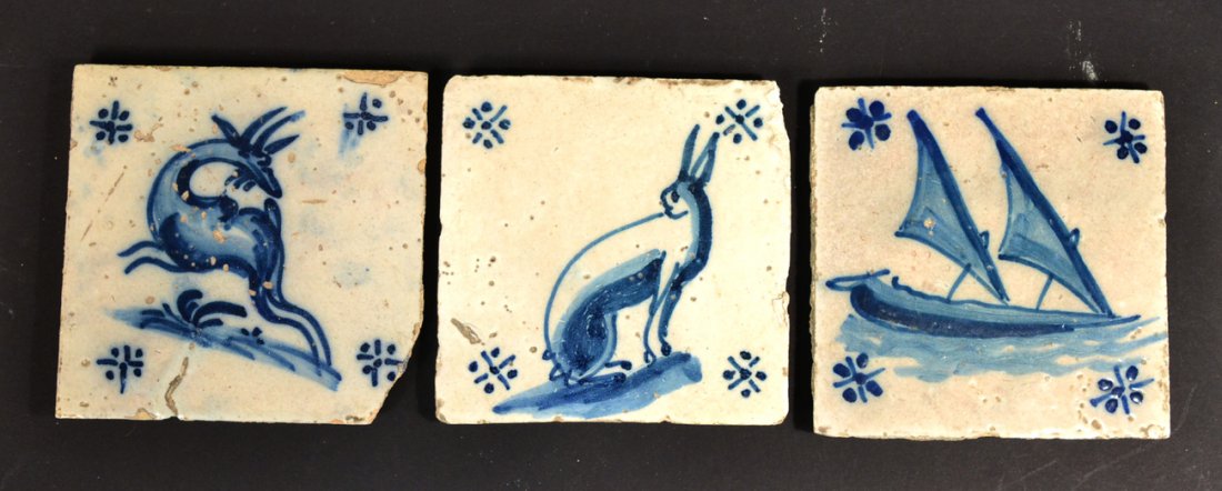 Three Antique Tiles, Possibly Delft: Blue and white tin-glazed earthenware tiles depicting: 1.) sailboat, 2.) rabbit, 3.) stag. [5 5/8" x 5 5/8"]. Two bear losses to corner. All with small amount of flaking. Possibly Delft.
