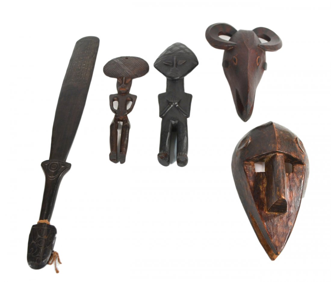 5 African Wood Carvings: Comprises; 2 masks, 2 figures, and a paddle. [Height of largest: 25 1/2"].