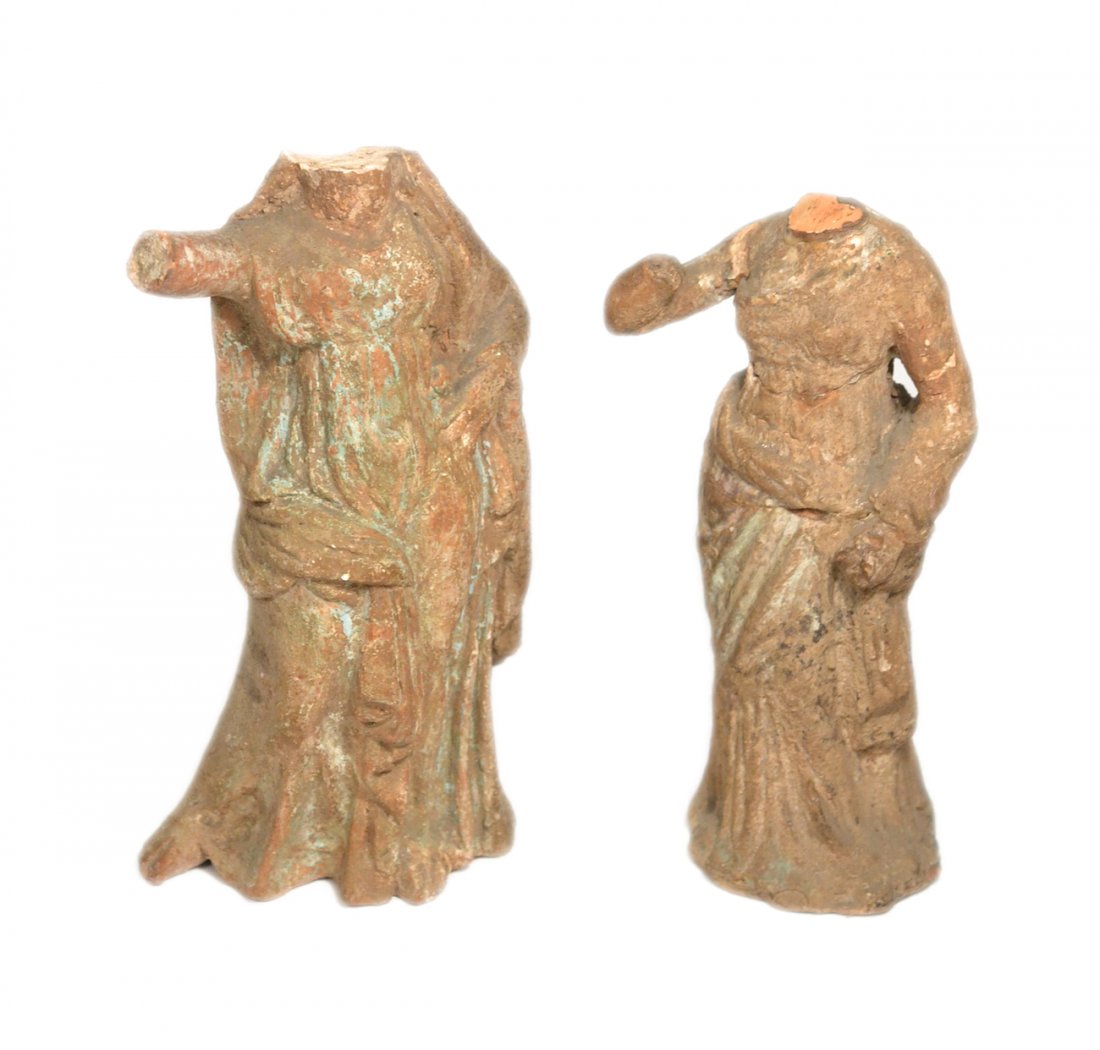 Two Tanagra Figures: Two earthenware female figures. [7" H]. Both lacking heads. One restored.
