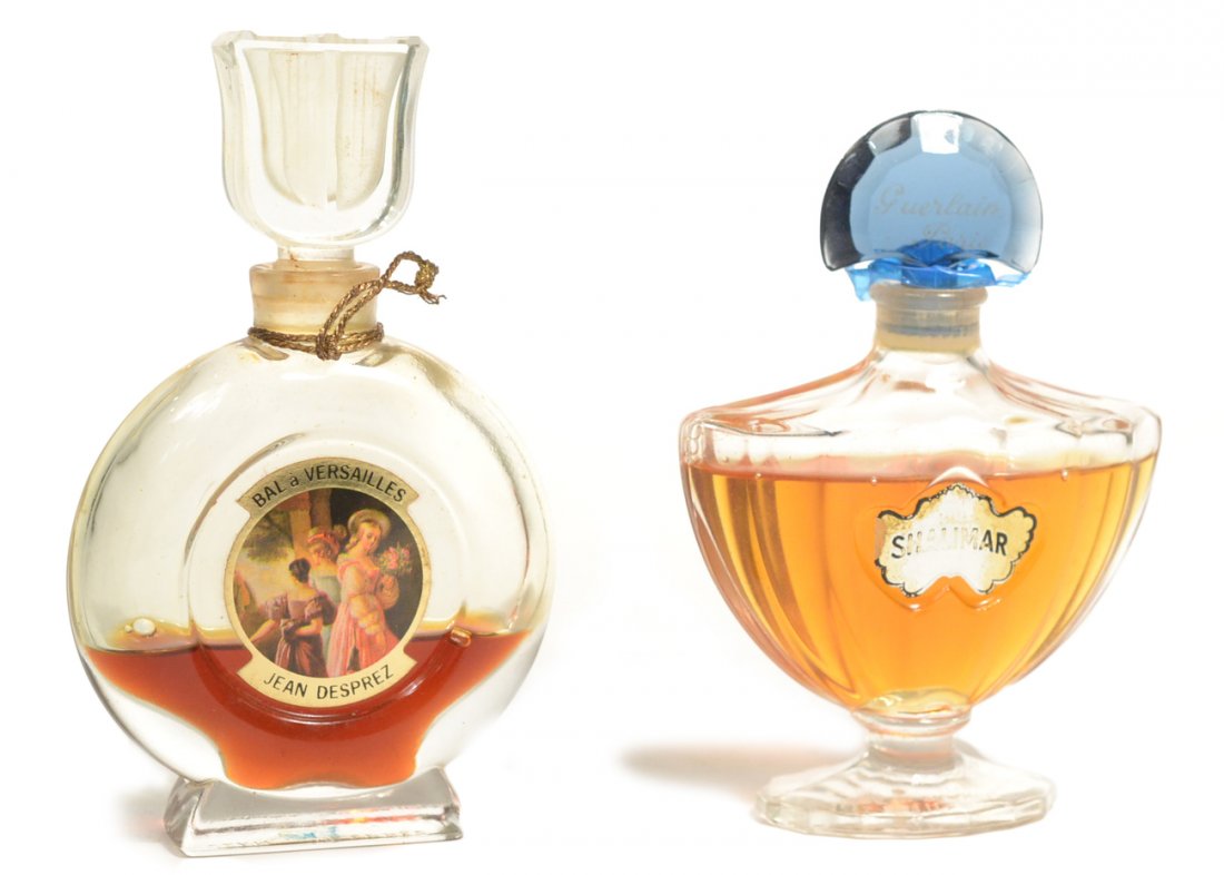 Vintage Perfume Bottles: Comprises: 1.) Guerlain "Shalimar" bottle with blue stopper [4" High]. Metalic paper label worn. In original purple presentation box ("as is" with rubber band residue and fading). 2.) Jean Desprez "Ba