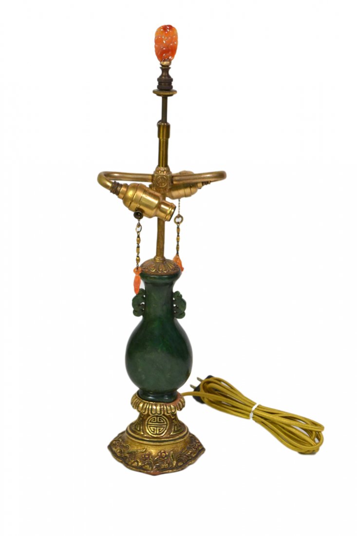 Chinese Jade Lamp: A fine Chinese boudoir lamp with rich green jade vase-form with gilt wood and bronze mounts and carnelian finial and pulls. Circa 1920's. In fine condition. [Jade only: 5 1/4"; Overall: 17 1/4"].