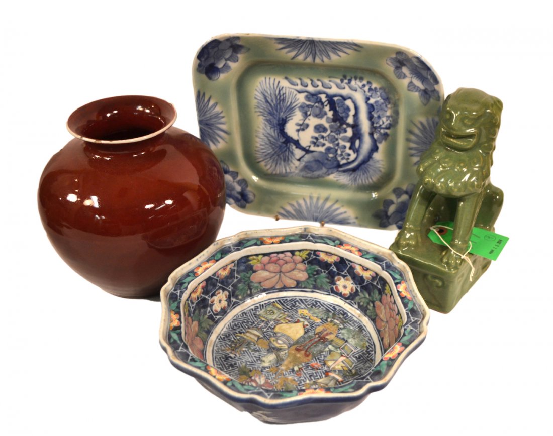 Four Asian Ceramics Articles: Comprises: 1.) Sang de boeuf vase (small chips). 2.) Celadon glazed foo dog. 3.) Celadon and blue glazed oblong platter (small chips). 4.) Floral decorated bowl (wear to glaze). [Largest: 8" H].