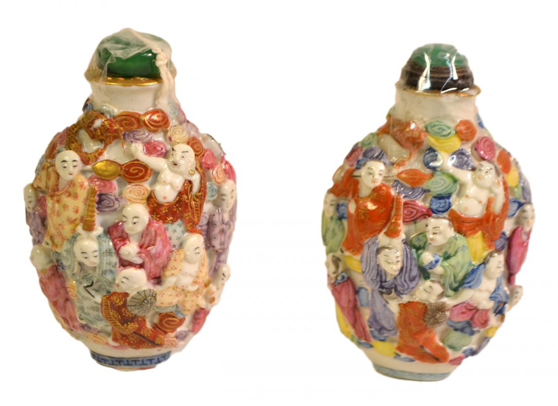 Pair of Asian Figural Snuff Bottles: Colorful ceramic snuff bottles, each featuring: 15+ Buddhist figures among multi-color clouds and green cabochon stoppers. Both marked on bottom. [2" W x 1 5/8" D x 3 1/4" H]. One stopper not original