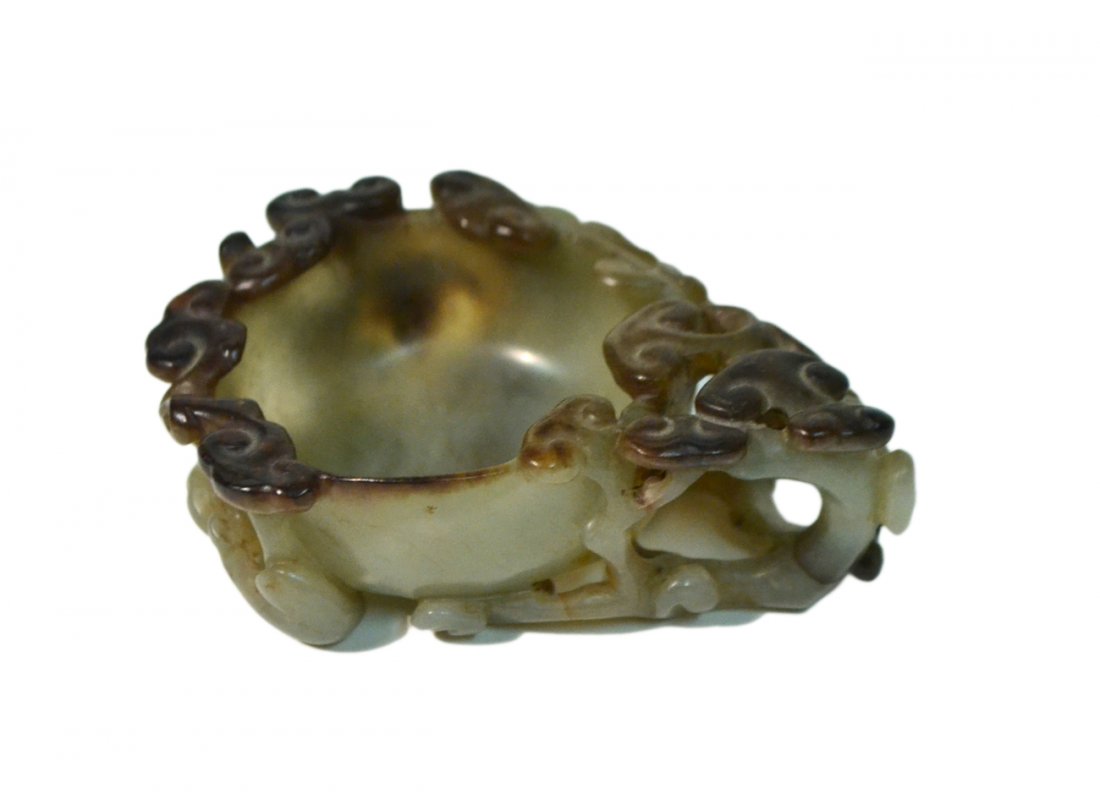 Chinese Jade Dish: The carved circular bowl surrounded by a trailing vine forming a handle. Greyish-green jade with brown mottling. In good condition. [3 3/4" W x 3 1/4" x D x 1 1/4" H].