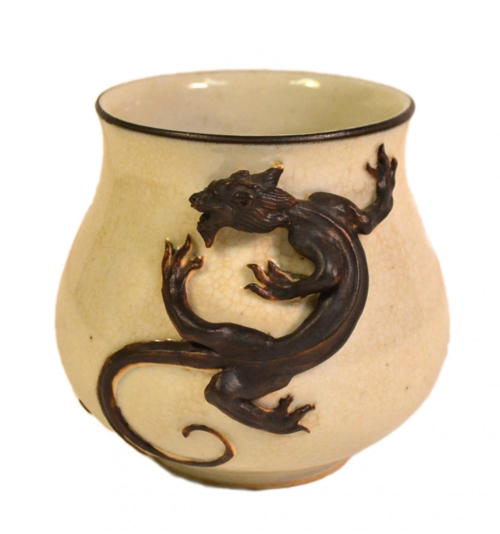 Asian Ceramic Dragon Bowl: Creme glazed earthenware bowl featuring a high relief stylized dragon with split tail. [4 1/8" Dia x 3 7/8" H]. Good condition.