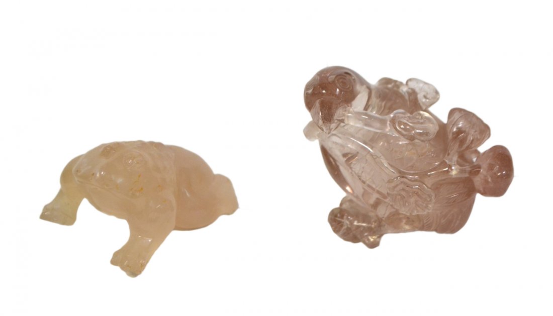Two Asian Carved Stone Animals: Comprises: 1.) Mutton fat jade toad. [2 1/8" W x 3" D x 1 1/8" H]. Losses to toes and proper left hind foot. 2.) Rutilated rock quartz bird with leafy twig bearing fruit in its beak. [3" W x 2 1/4" D