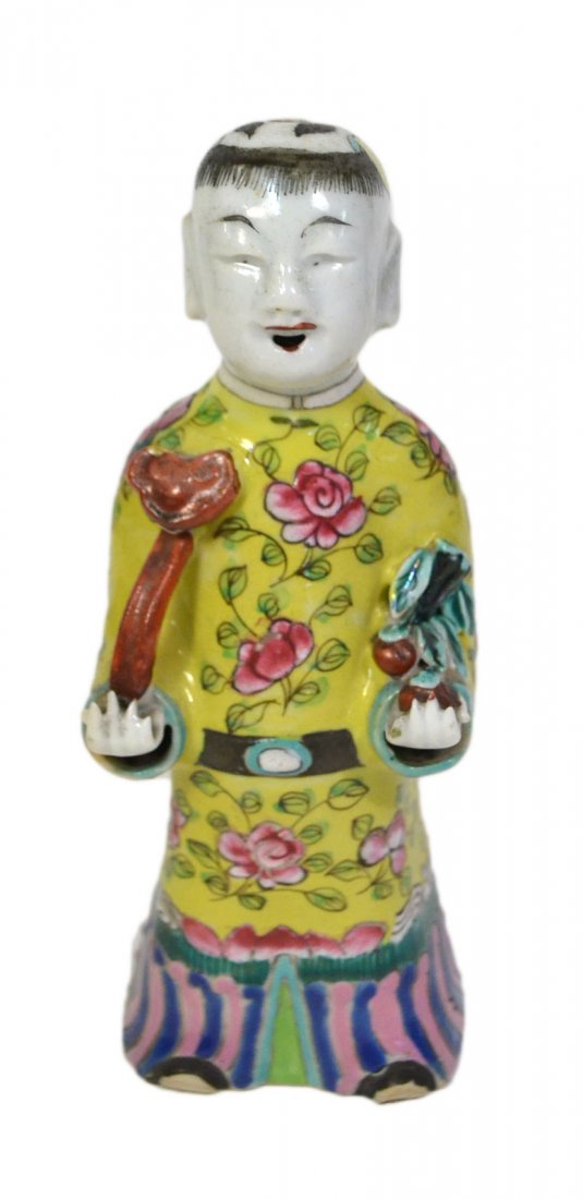 Chinese Porcelain Figure of a Boy: The youthful figure in yellow robe with polychrome enamel decoration and carrying scepter and fruit. [7 1/4" H]. Good condition.