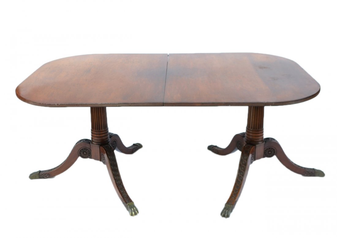 Regency-Style Dining Table: Regency-style mahogany double pedestal dining table with one leaf. [66" W x 42" D x 28" H; Leaf: 20" D]. Scratches and wear.
