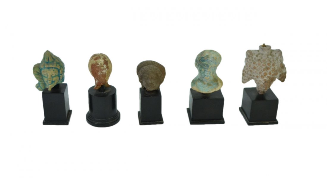 4 Ancient Ceramic Female Heads & Bottle: Includes terracotta and glazed ceramic specimens from 1 1/2" H to 1 7/8" H. Two relief and two in-the-round. All mounted on ebonized wood plinth bases [Tallest: 3 1/2"]. Accompanied by a terracotta gr