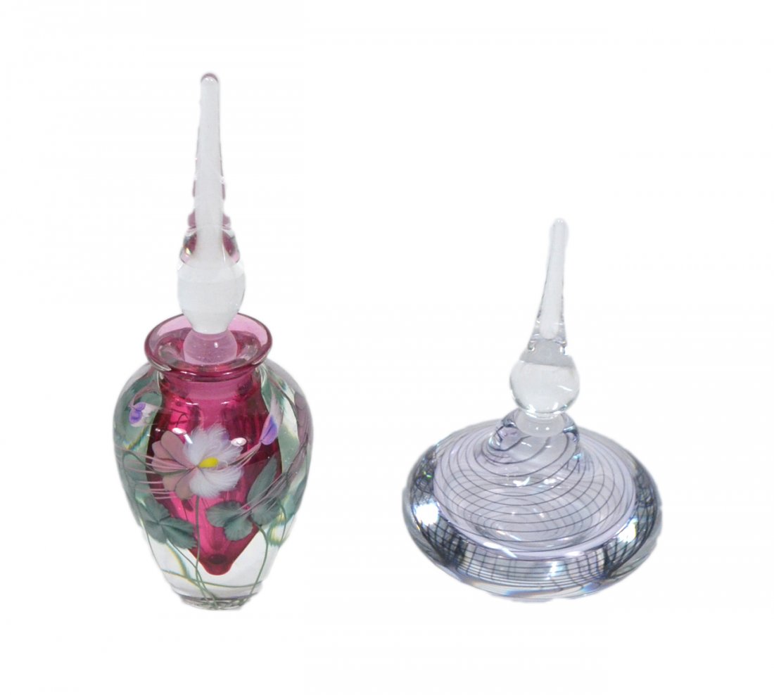Two Art Glass Perfume Bottles: Two art glass perfume bottles with stoppers. Vandermarel and Daniel S. Lundberg Studios. [Tallest: 7" H] One stopper chipped, otherwise in good condition.