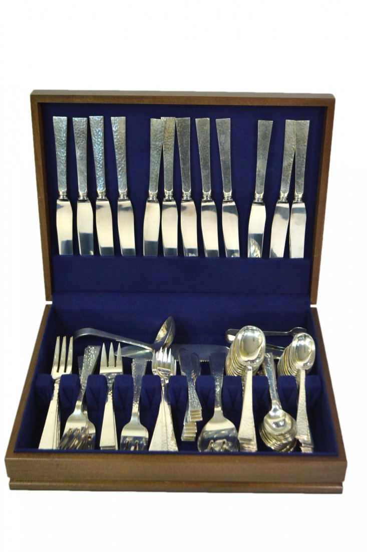 104-Pc Allan Adler Sterling Flatware Set: An outstanding hand-hammered Martelé set comprising: 12 dinner knives, 12 shrimp cocktail forks, 12 tablespoons, 24 teaspoons, 12 dinner forks, 12 salad forks, 12 butter spreaders, 2 serving forks, 3