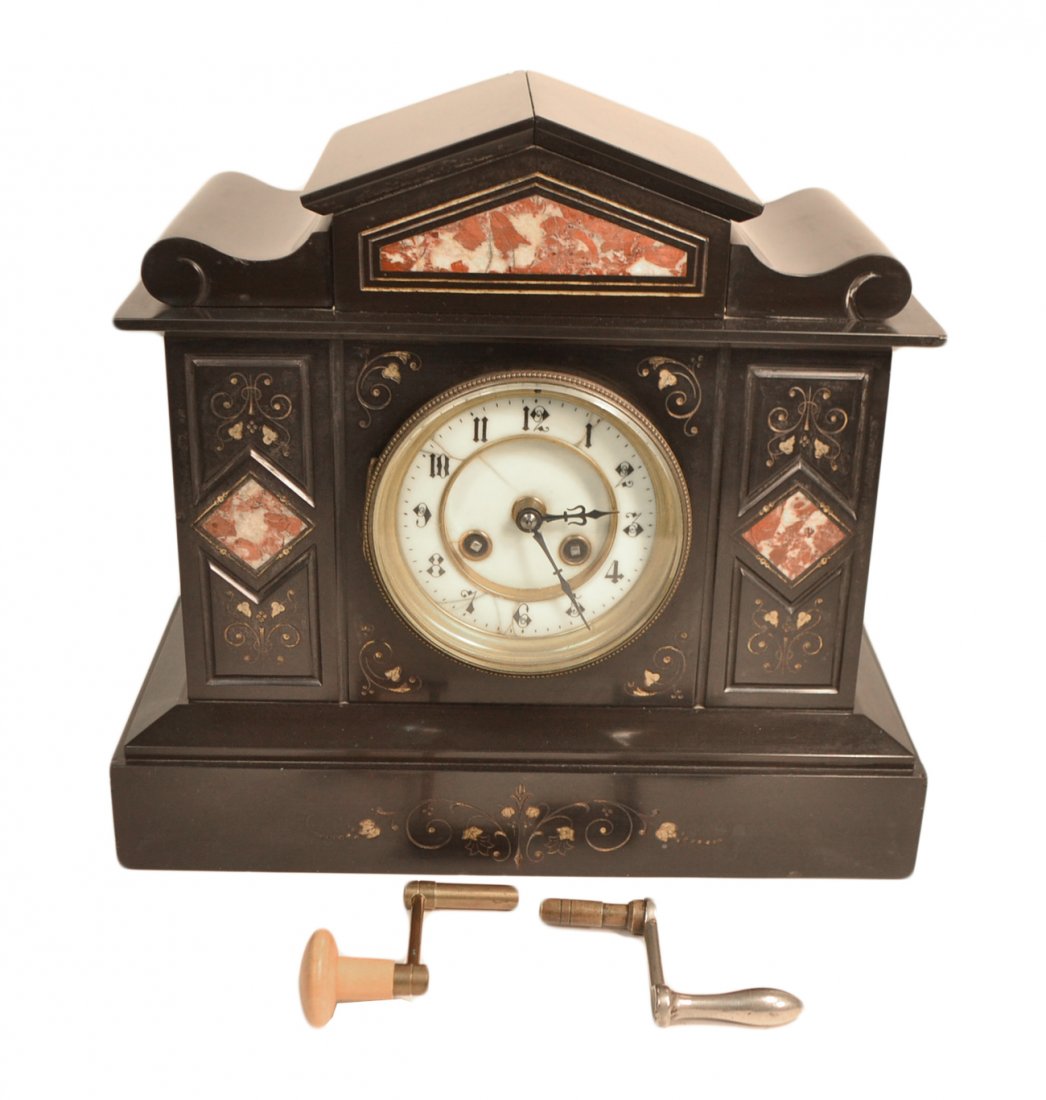 Marble Mantle Clock: Black marble incised clock with inset rouge marble, porcelain face (as is). Works made in France. [12 1/2" x 6 1/4" x 11 1/2" H approx.]. Two keys. Chip on left side. Minor losses.