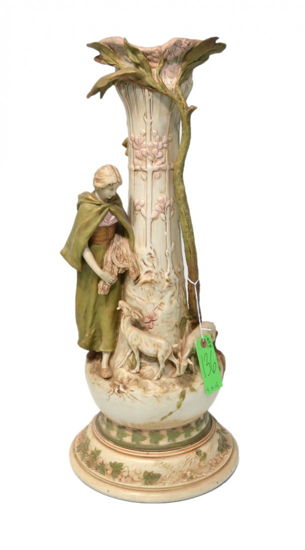Royal Dux Figural Vase: A Royal Dux ceramic vase with a decorated woman and goat. [25" H x 10-11" Dia]. Rim on base drilled, good condition.