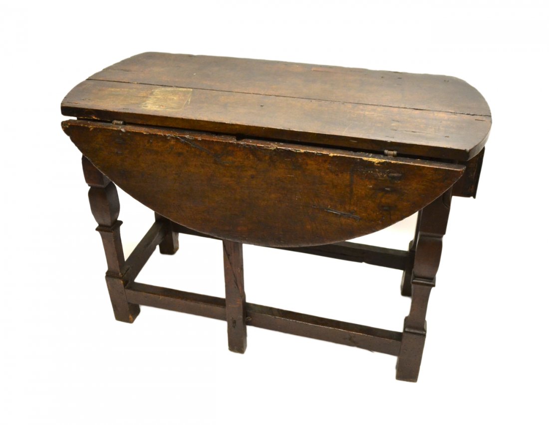 Antique Tudor Drop-Leaf Table: 17th/18th century walnut drop-leaf gateleg table having a drawer at each end. [44" L x 45" 1/2 D x 31 1/2" H]. Splits, losses as with age. One missing gateleg.