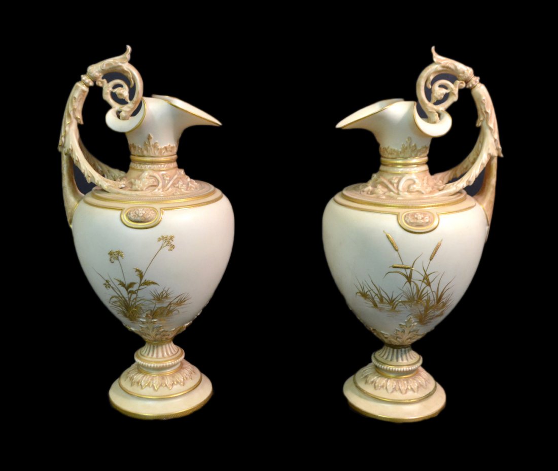 Pair of Royal Worcester Porcelain Ewers: With raised gilt and molded decoration. Each with puce maker's mark and #1309. [13 1/2" H]. Good condition.