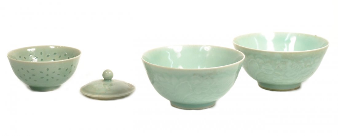 Group of Celadon Porcelain Articles: Comprises: 1.) Pair of footed bowls with low relief koi fish among aquated vegtation [5 7/8" Dia. x 2 7/8"H]. 2.) Finger bowl with pierced and glazed geometric design [4 1/2" Dia. x 2 1/4" H] 3.) Dome