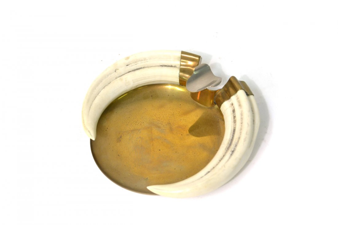 Brass Ash Receiver: Mounted with two faux tusks. [7 1/2" W x 7" D x 1 1/2" H]. Wear commensurate with age.