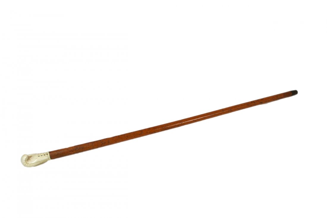 Antique Walking Stick - Boxing Motif: Burl wood shaft with carved ivory boxing glove handle and metal tip. [36 1/2" Long]. Surface wear to wood commensurate with age.