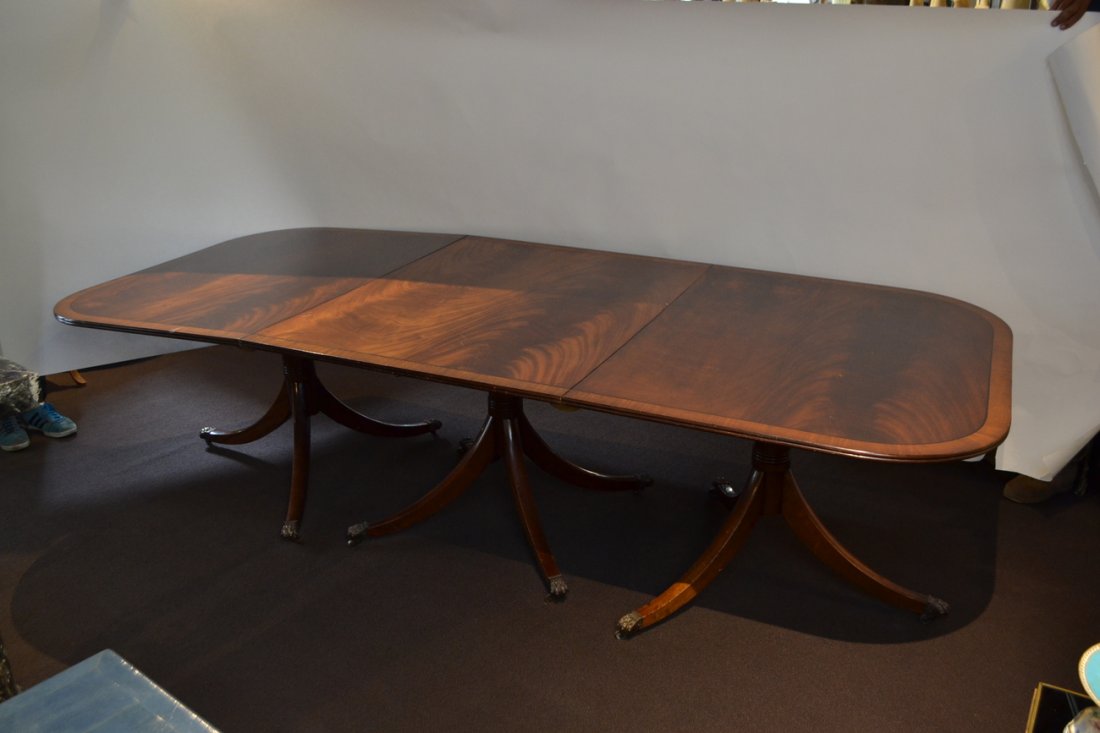Sheraton-Style 3-Pedestal Dining Table: Fine mahogany triple-pedestal dining table with three leaves. A few light surface scratches, small loss to cross-banding. [72" closed x 48" D x 29" H; 144" W open].