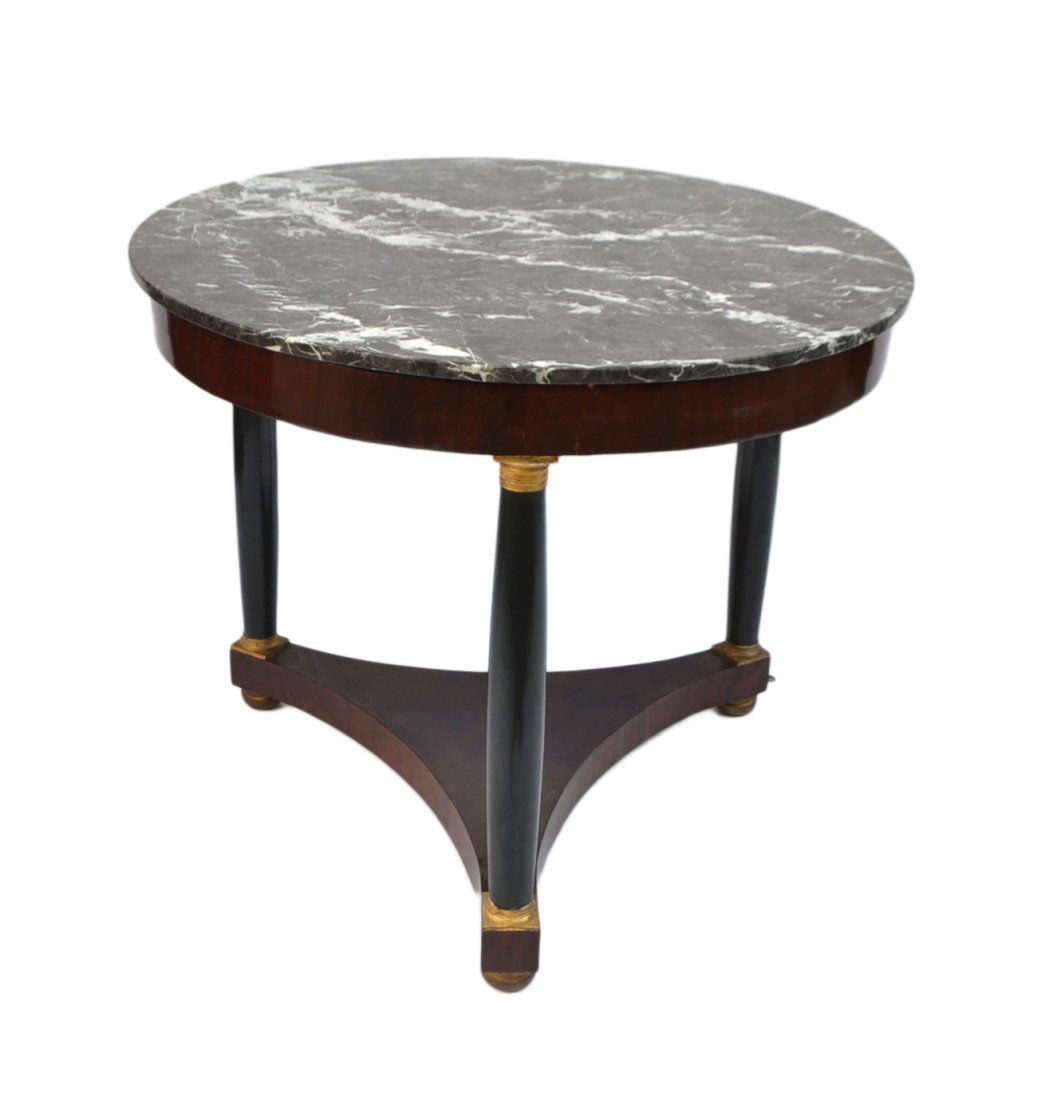 French Empire Gueridon: Circular mahogany table with three ebonized columnar supports and bronze mounts supporting a black and white circular marble top. [30 1/2" H x 36 1/4" Dia.] Good condition.