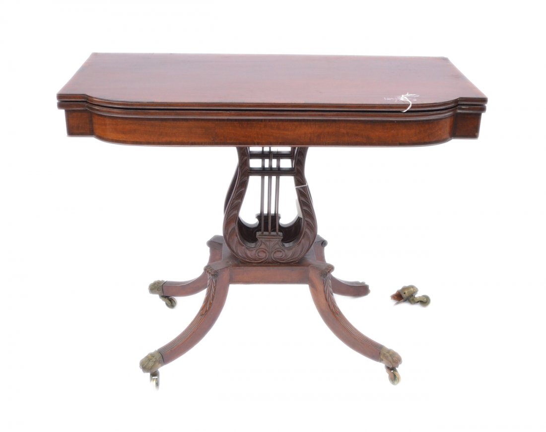 Duncan Phyfe Game Table: A lyre base lift top mahogany and banded inlaid card/game table. 19th century. Some losses, veneer replacement and blemishes. [35 3/8" W x 17 1/2" D x 27 1/2" H].