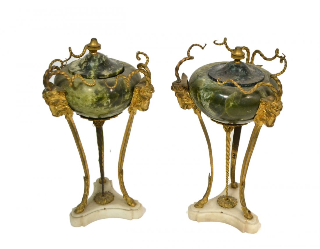 Pair of Neoclassical-Style Urns: Each with green stone covered vessel on gilt metal tripod base with three ram's head masks. [11 1/2" H]. Each one lacking one ram horn and one lid mismatched in color.