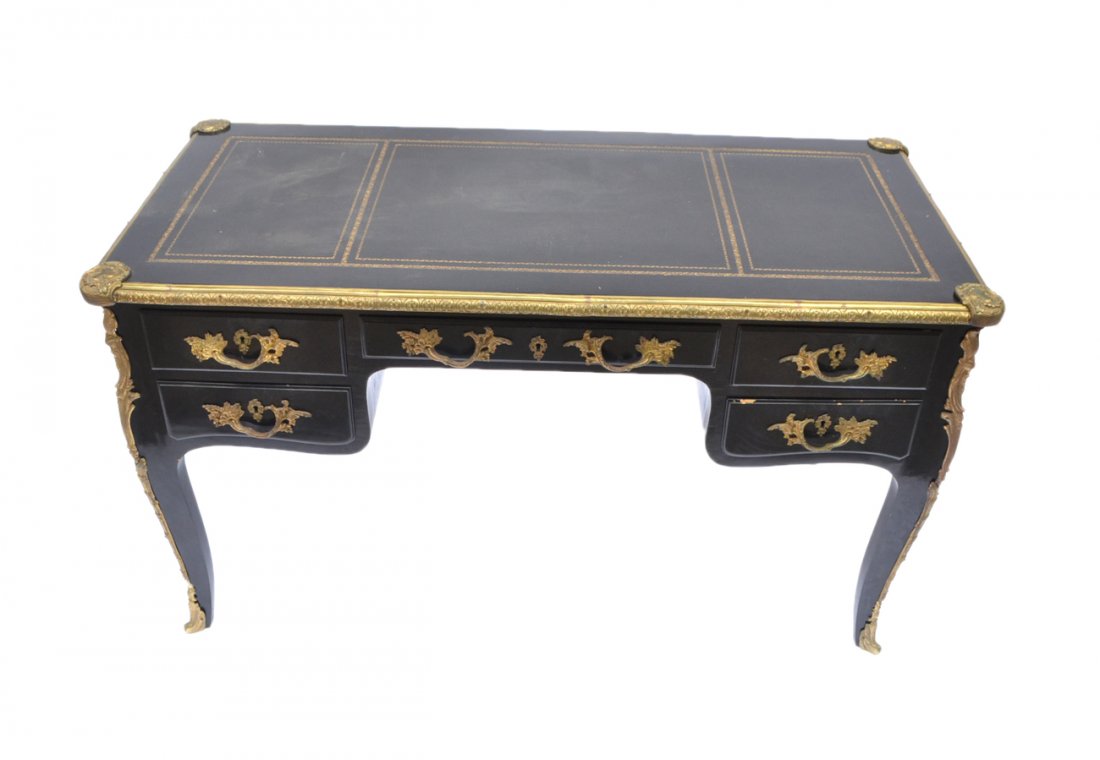French Ebony Bureau Plat: Louis XV-style black painted bureau plat with bronze trim and mounts with a black-gold tooled leather top with slides. Faux drawers on one side. [53" W x 25" D x 30 1/2" H]. Good condition.