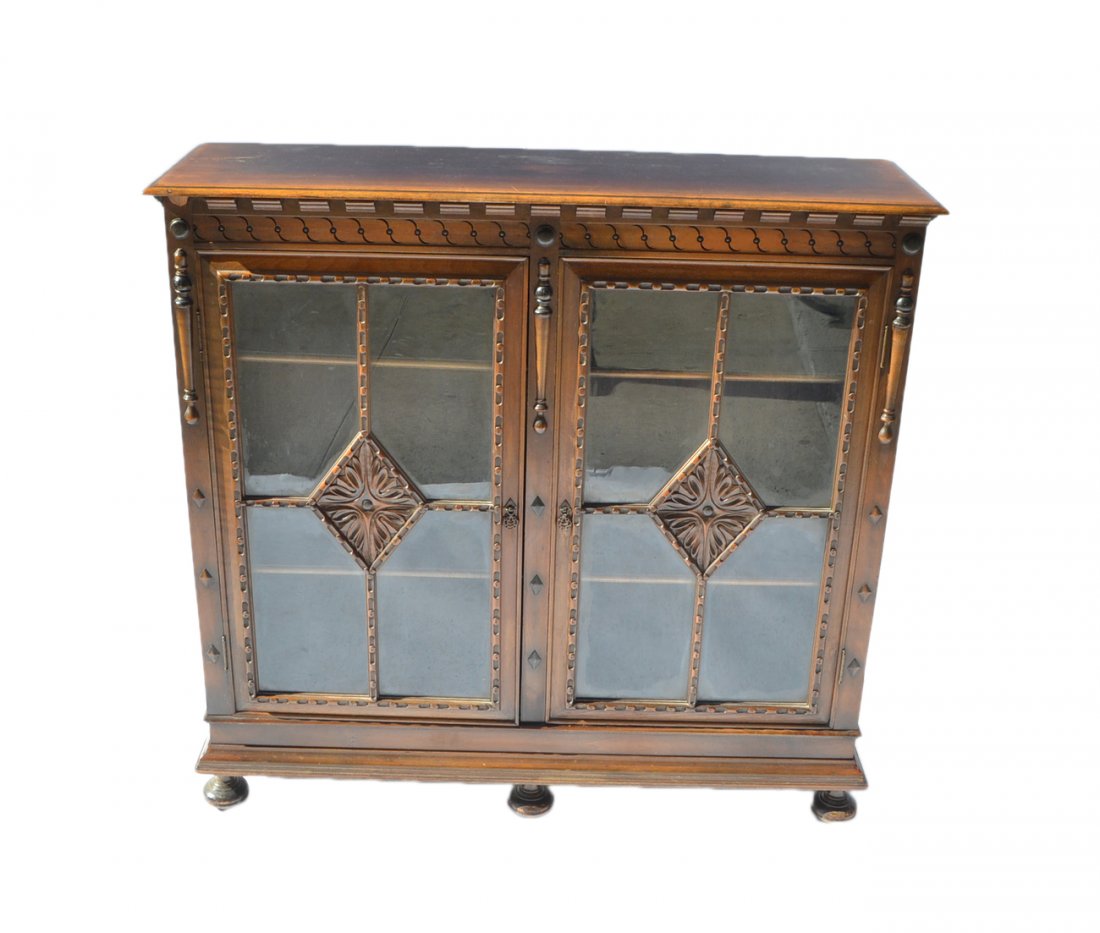 Tudor-Style Bookcase: Mahogany two-door mullion glass bookcase. [44 1/2" W x 13" D x 43" H].