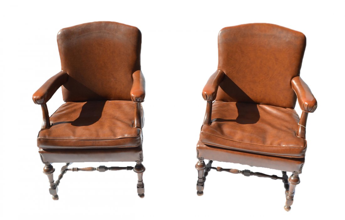 Pair of Tudor-Style Armchairs: Pair of mahogany chairs, each with brown leather upholstery. Good condition.