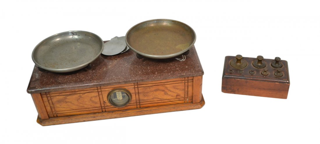Vintage Henry Troemner Balance Scale: Scale contained within an oak case bearing a marble top and dual trays with balance indicator behind a glass window. [19 1/2" W x 9 1/8" D x 7 1/2"]. Wear with pitting to original trays. Accompanied b