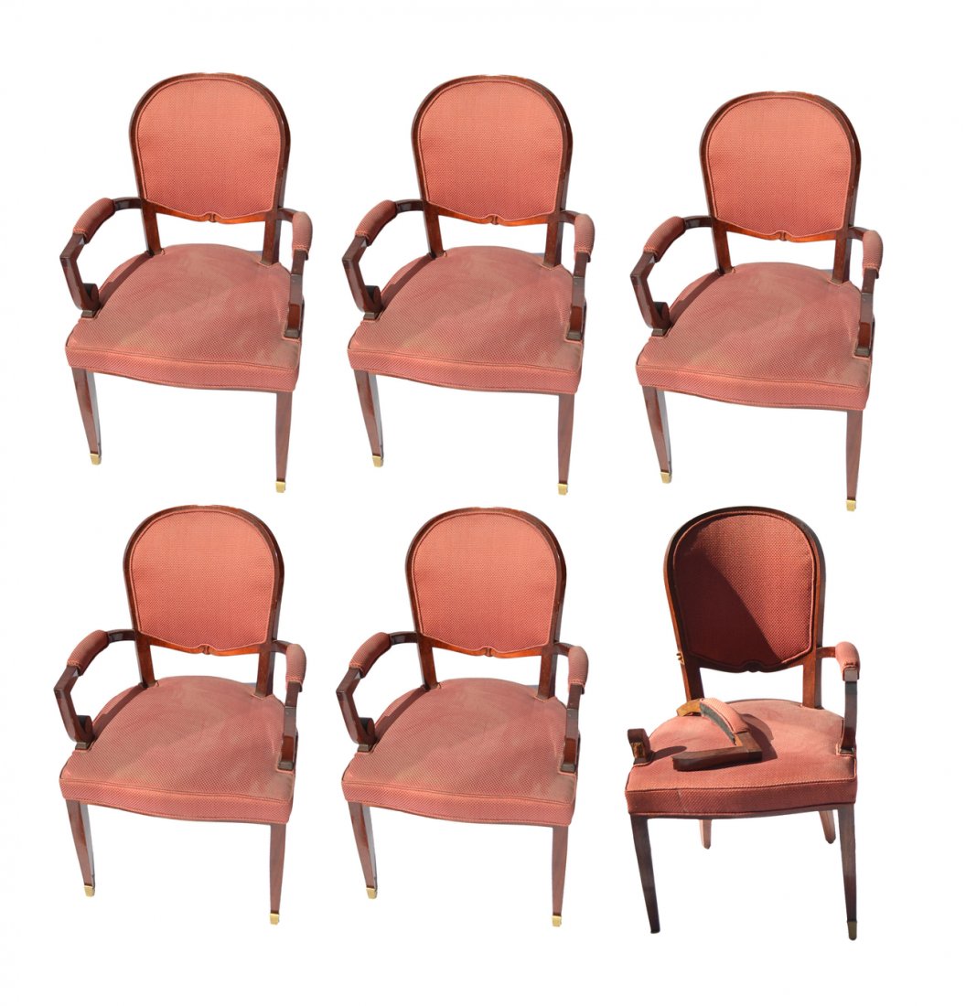 Set of 6 Modern Open Armchairs: in the manner of Tommi Parzinger. Mahogany with upholstered seats, backs and armrest. [23" W x 20" D x 36 1/2" H to seat]. Scratches and scuffs. One chair bears loss to arm. Broken arm has been repair