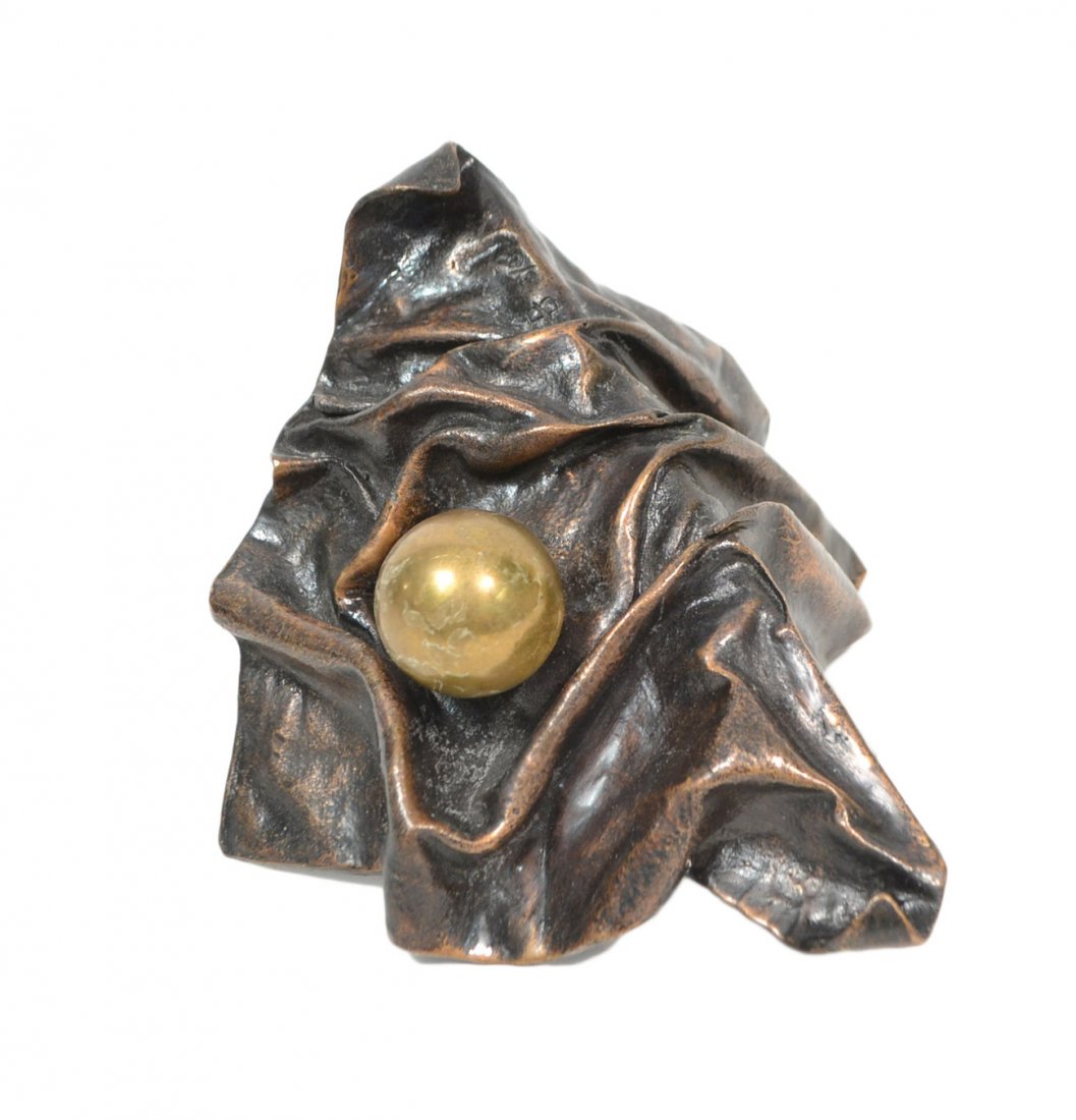 Patrice Breteau, Bronze Sculpture: Titled "Happy Birthday". A trompe l'oeil study of drapery rendered in bronze with a gilt ball resting atop. [9 1/2" W x 7" D x 8 1/2" H]. Good condition.