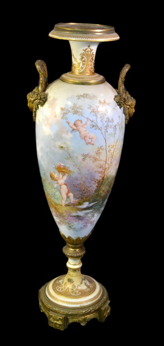 Bronze Mounted Signed Sevres Vase: Features an elaborate allegorical scene with putti, bacchanalia figures, woman with a child, and various birds. Signed lower right "Ch[arles] Fuchs". Bears bronze neoclassical style mask handles and m