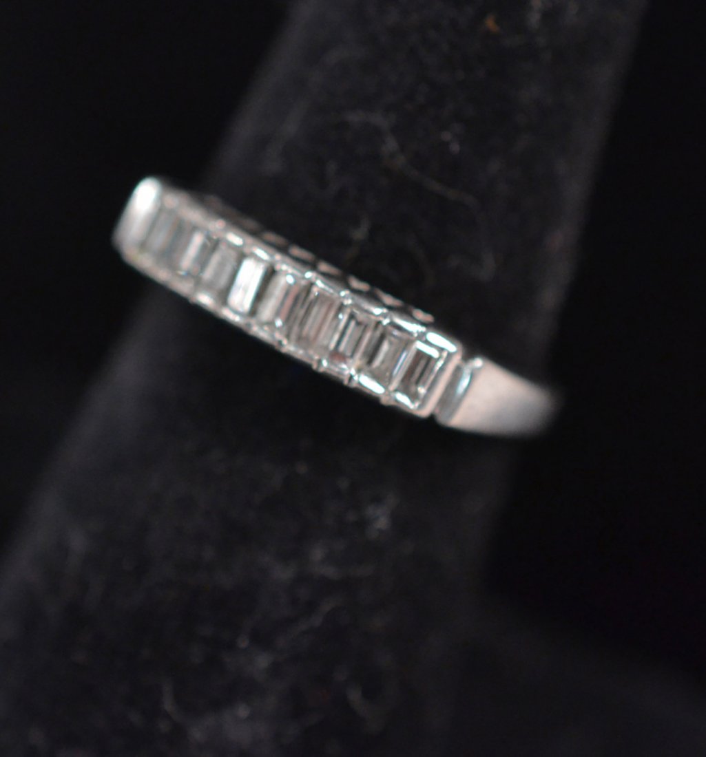 Platinum and Diamond Wedding Band: Platinum band mounted with 10 baguette cut diamonds. Good condition. Size 6.